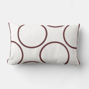 cercles marron sur un oreiller moderne blanc