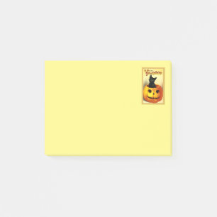 Chat d'Halloween assis dans un Post-it de citrouil