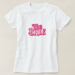 Chic 3D 'The Bride' Pink Script Bridal T-Shirt<br><div class="desc">Celebrate your new title in style with this Chic 3D 'The Bride' Pink Script Bridal T-Shirt. The eye-catching 3D effect script in a luscious shade of pink adds a playful yet stylish touch to your bridal wardrobe. It’s a perfect choice for engagement parties, bridal showers, or as a fun outfit...</div>