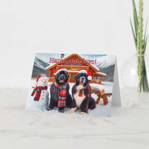 Chiens de Terre-Neuve à côté d'une carte de Noël d