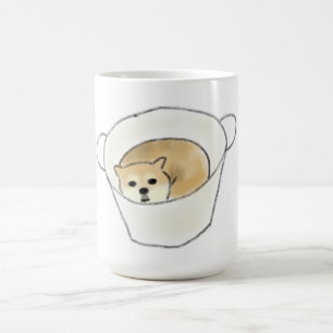 Chiots Shiba Inu se reposant dans une tasse blanch