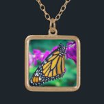 Collier Plaqué Or Papillon monarque orange photo fleur violette auda<br><div class="desc">Photo de fond d'un papillon de monarque délicat, orange et noir posé sur une fleur de magenta vive. Explorez les pensées des jours chauds et ensoleillés chaque fois que vous portez ce collier de charme photo coloré et étonnant. Ce collier se présente en petites, moyennes et grandes tailles, ainsi qu'en...</div>