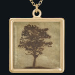 Collier Plaqué Or Silhouette d'arbre sur Arrière - plan de bronze<br><div class="desc">Un arrière - plan de bronze sert de scène à cette silhouette d'arbre avec des branches qui se balancent dans la brise. On a presque l'impression de se reposer le dos contre cet arbre,  de s'asseoir à terre et de faire une longue sieste.</div>