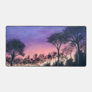 Computer desk keyboard matt with trees at sunset