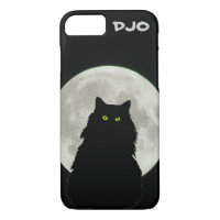 Chat noir assis à la Pleine lune