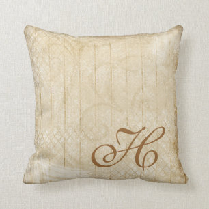 Coussin affligé de décor de monogramme d'or et de