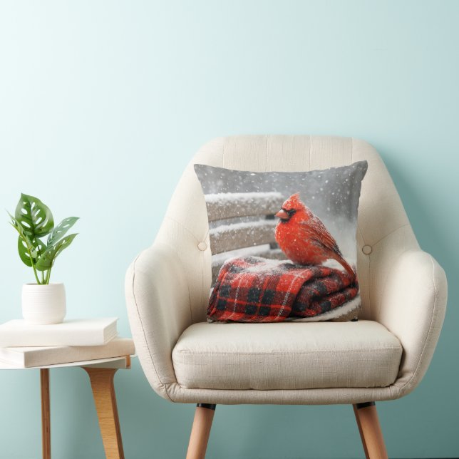 Coussin Cardinal rouge de Noël sur une couverture à carrea (Chaise)