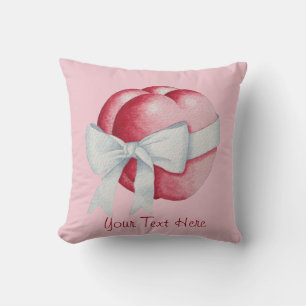 Coussin coeur d'amour rouge attaché à un arc blanc