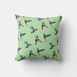 Coussin De mignons colibris multicolores sur fond vert oli