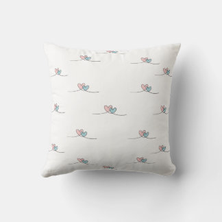 Coussin Deux coeurs avec ailes, un rouge et un bleu
