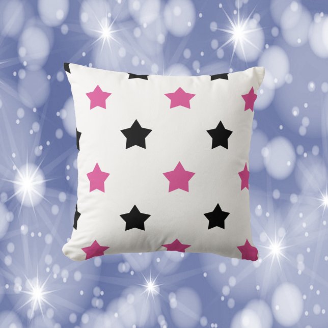 Coussin Étoiles noir et rose Motif blanc (A throw pillow with a pattern of pink and black stars.)
