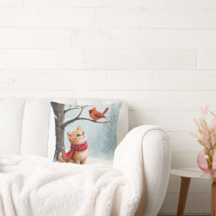 Coussin Ginger Kitty regarde un cardinal d'hiver