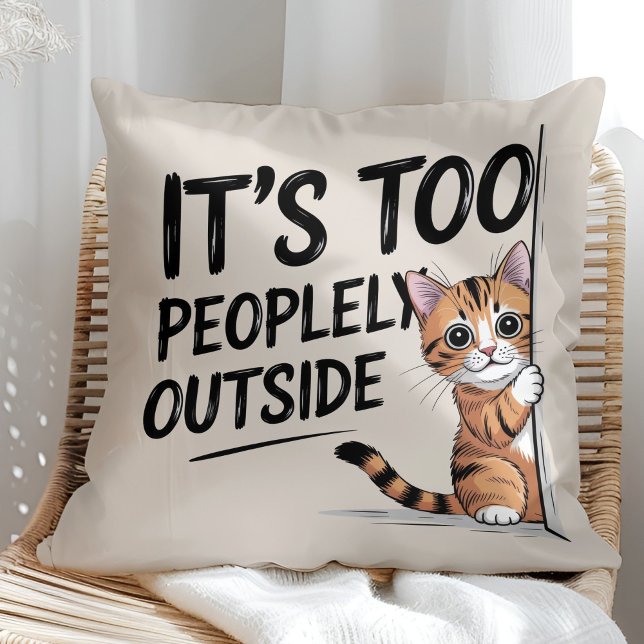 Coussin "It's Too Peopely Outside" Funny Introvert Cat ("It's Too Peopely Outside" Funny Introvert Cat Throw Pillow in a sunny boho rattan chair.)