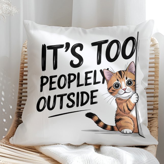 Coussin "It's Too Peopely Outside" Funny Introvert Cat ("It's Too Peopely Outside" Funny Introvert Cat Throw Pillow in a sunny boho rattan chair.)