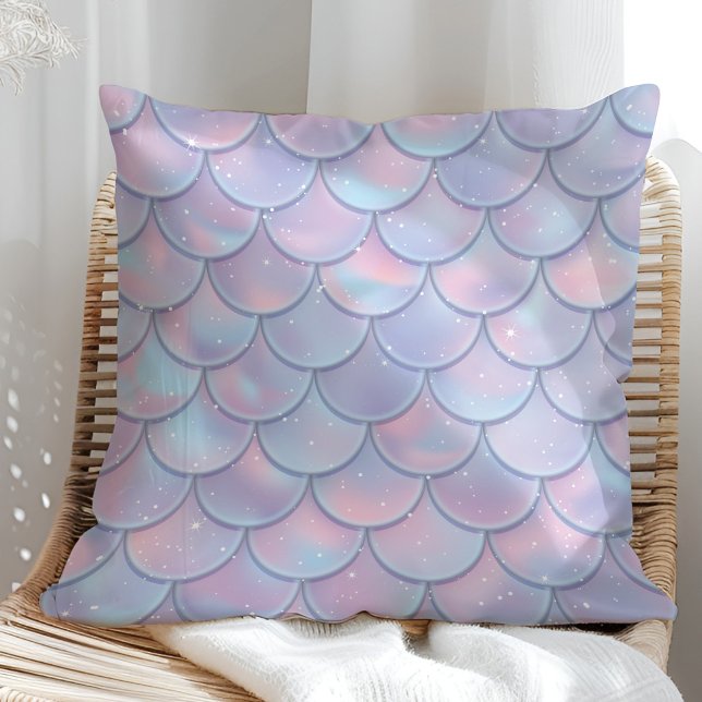 Coussin jeté en écailles de sirène pastel (Lilac Holographic Mermaid Scales Throw Pillow in a sunny rattan armchair.)