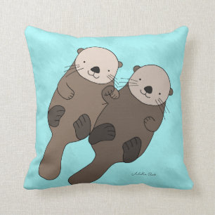 Coussin La loutre tenant des mains reposent le carreau