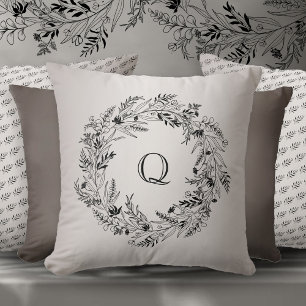 Coussin Lettre Q cercle de feuillage noir gracieux