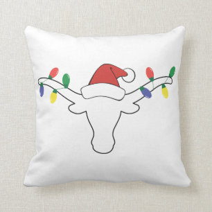 Coussin Longhorne blanche avec lumières de Noël et chapeau