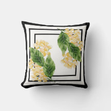 Coussin noir et blanc avec fleurs jaunes