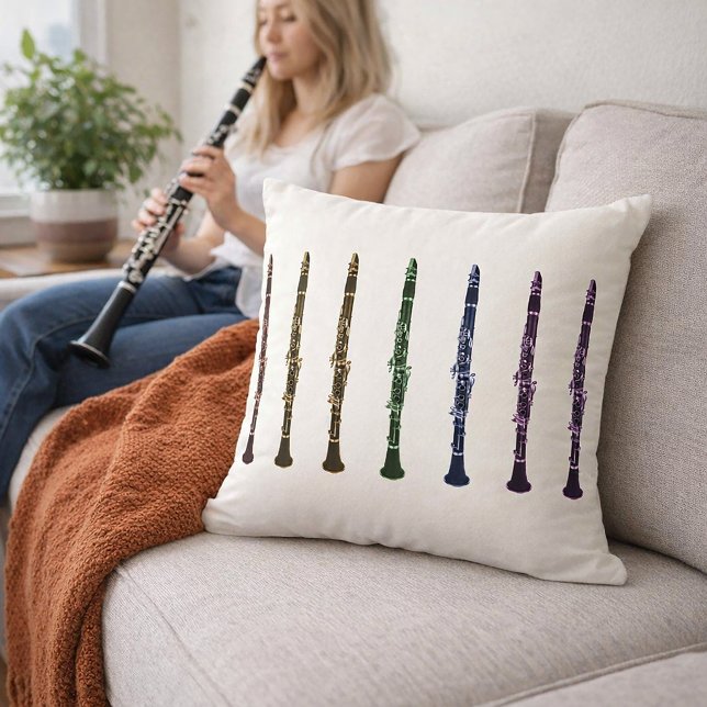 Coussin Orchestre de clarinettes arc-en-ciel vibrant (A throw pillow with a rainbow lineup of clarinets in red, orange, yellow, green, purple, blue & pink)