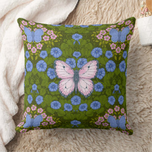 Coussin Papillons et symétrie des fleurs, bleu et rose