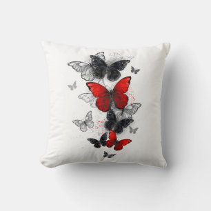 Coussin Papillons noirs et rouges volants