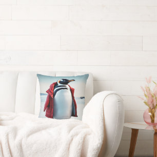 Coussin Penguin de Noël portant un manteau rouge
