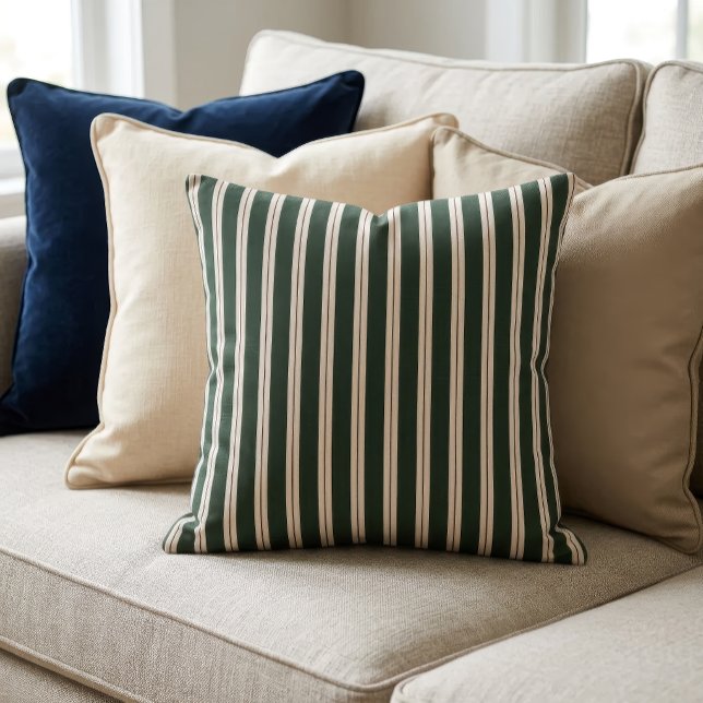 Coussin Rayures Rétro - Vert foncé, Beige et Rouge foncé (A pillow with a retro inspired stripe pattern sits on a couch in front of several other pillows.)