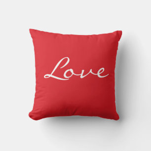 Coussin rouge et blanc avec typographie d'amour