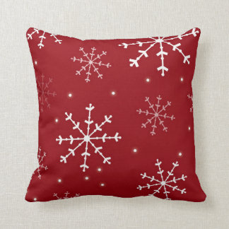 Coussin rouge et blanc de flocon de neige