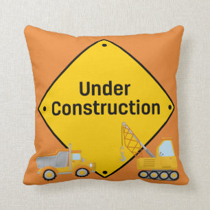 Coussin Signe en construction avec des camions