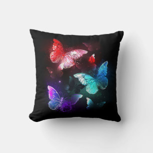 Coussin Trois papillons lumineux sur fond de nuit