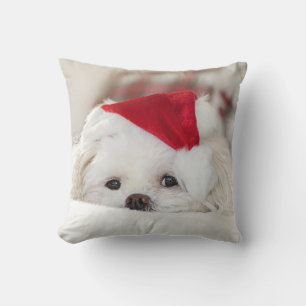 Coussin Un mignon chien blanc dans un Casquette de Noël ro