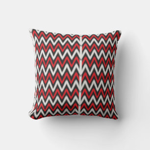 Coussin un motif en zigzag rouge et noir sur fond blanc