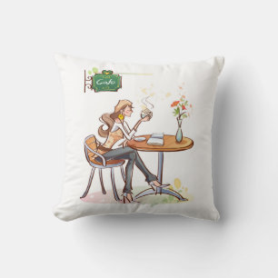 Coussin Une femme boit du café dans un mignon café