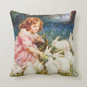 Coussin Une petite fille qui nourrit les lapins