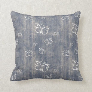 Coussins bleus et crèmes sales de motif de