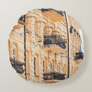 Coussins Ronds An old yellow house with wrought-iron balconies. f