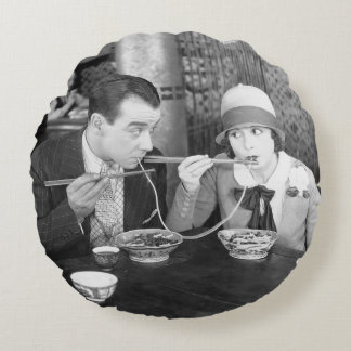 Coussins Ronds Couple sharing a noodle in a restaurantvintage, fo