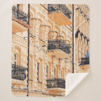 Couverture Sherpa An old yellow house with wrought-iron balconies. f