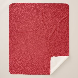 Couverture Sherpa Closeup en cuir artificiel rouge foncé.
