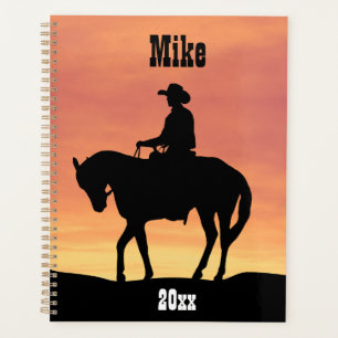 Cowboy à cheval au coucher du soleil