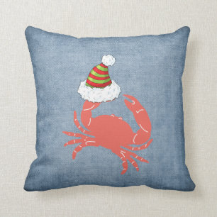 Crabe tenant le coussin de Noël de casquette de
