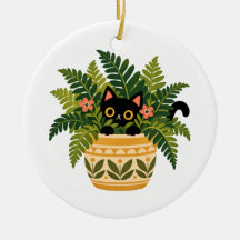 Chat noir regardant depuis une jardinière botaniqu