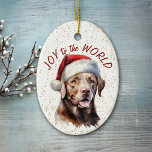 Décoration En Céramique Chocolat Labrador Retriever Dog Joy au monde<br><div class="desc">Sur le devant de cet ornement de vacances est une belle image d'un chien de Labrador Retriever brun chocolat dans un casquette du Père Noël. Derrière l'image se trouve un arrière - plan à confettis doré. Le texte rouge dit "Joy to the World". Le dos de l'ornement a le même...</div>