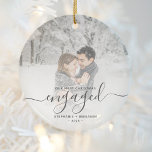 Décoration En Céramique Premier Noël Engagé Photo personnalisée Gris Scrip<br><div class="desc">Commémorez votre fiançailles avec ce magnifique ornement de gardien moderne. Le texte en gris fusain dit "Notre premier Noël engagé", avec le mot "engagé" dans un élégant script d'écriture manuscrite avec des fioritures avant et après. Remplacez l'exemple d'image par votre photo préférée, et ajoutez vos noms et l'année. Un filtre...</div>