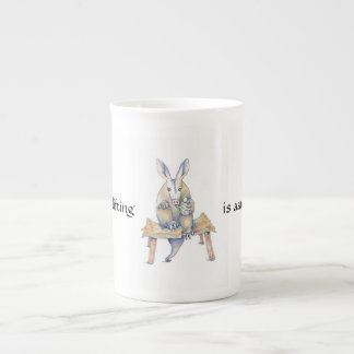Dessin d'Aardvark assis et buvant d'une tasse