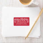 Étiquette Merry Christmas Modern Red Return Address<br><div class="desc">Holiday return address labels feature modern white script "Merry Christmas" writing with festive holly branches and berry accents. The poinsettia red background color can be customized.</div>