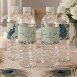 Étiquette Pour Bouteilles D'eau Élégant Mariage de Peacock Floral Sage Green<br><div class="desc">Ce Étiquette à bouteille d'eau Mariage Sage Green Floral présente un paon dessiné à la main en bleu et turquoise perché sur les branches de magnolia en pleine floraison, illustré à l'encre noire, contre un arrière - plan turquoise foncé moderne. Conçus pour les mariage, ces étiquettes colorés de bouteille d’eau...</div>