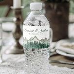 Étiquette Pour Bouteilles D'eau Rustic Watercolor Mountains & Pine Trees Mariage<br><div class="desc">Ces étiquettes de bouteilles d'eau rendront votre célébration mariage d'autant plus spéciale. Elles présentent un design rustique mais élégant avec un paysage aquarelle de sommets alpins avec une forêt de pins verts au premier plan. Il y a des lettres de script pour les noms du couple mariage et un endroit...</div>